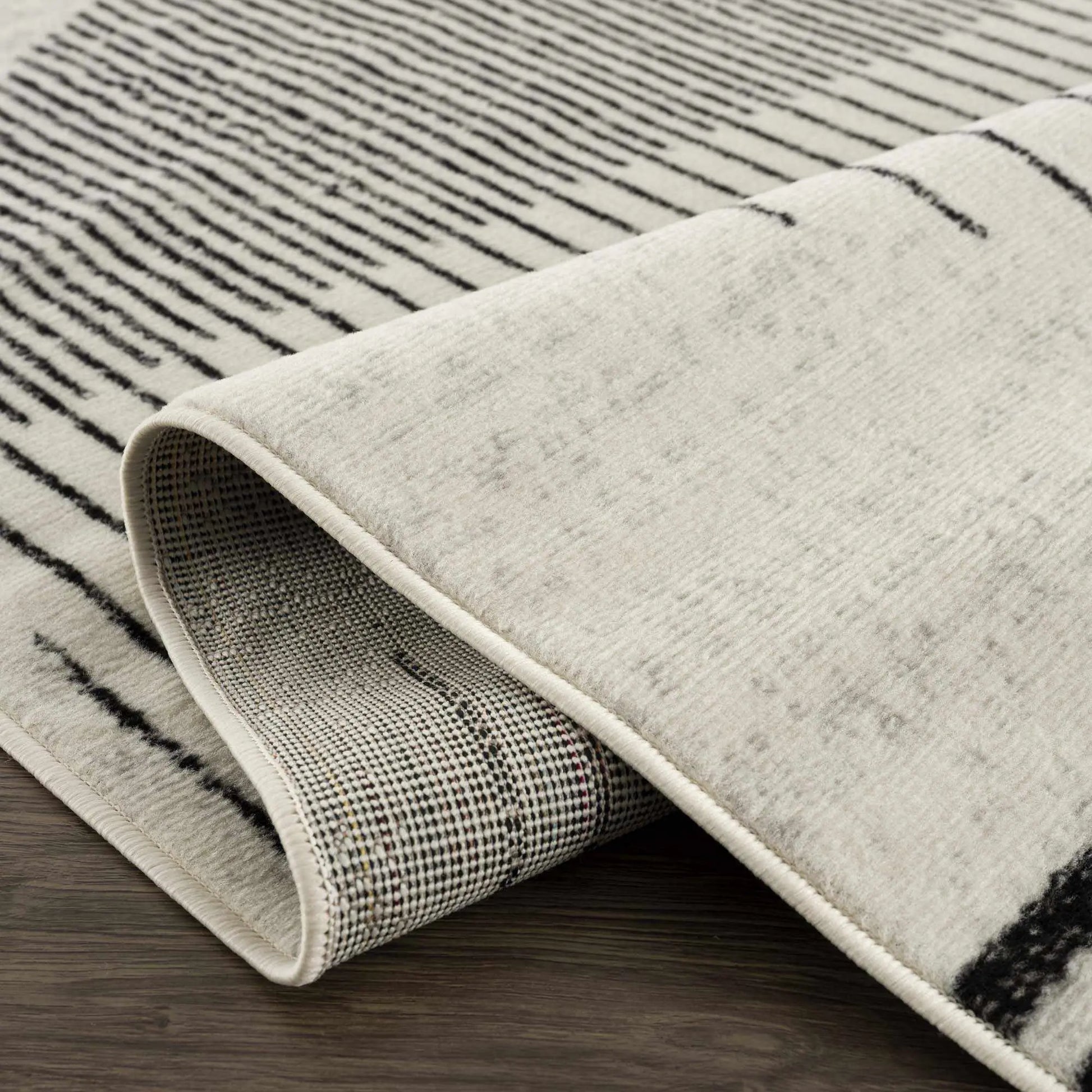 Angus Abstract Black and White Area Rug Hauteloom LLC